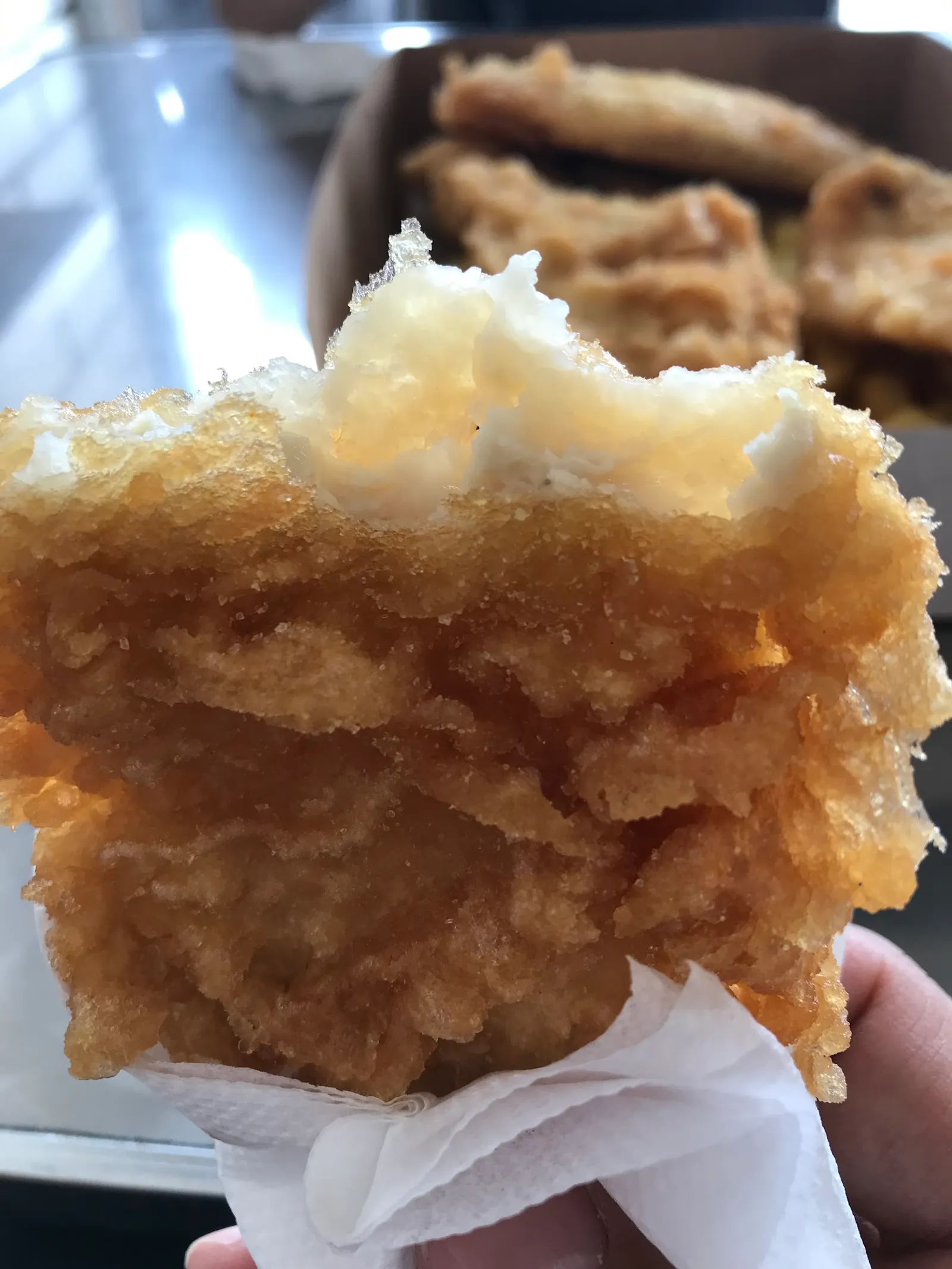 Close-up cross-section of battered flathead showing flaky white fish inside golden crispy batter